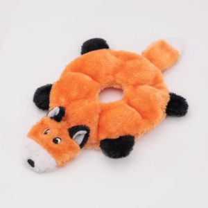 A round, plush toy resembling an orange fox with black paws and a white-tipped tail, featuring a hole in the center.