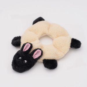 Plush doughnut-shaped toy with a black animal face, ears, and limbs attached to a white ring body.