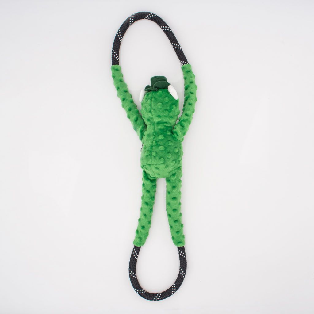 A green plush toy shaped like a frog with long, textured arms and legs, holding a black rope with white dots in its hands and feet against a white background.