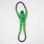 A green plush toy shaped like a frog with long, textured arms and legs, holding a black rope with white dots in its hands and feet against a white background.