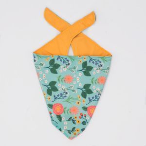 A Bandana - Teal Floral with a green floral print on one side and solid yellow fabric on the reverse is displayed on a plain white background.