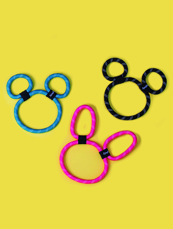 Three circular rope toys in the shape of animal ears and heads, colored blue, black, and pink, arranged on a yellow background.