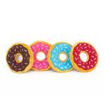 Four plush toy donuts in a row, each with colored icing: chocolate, pink, blue, and red, all decorated with white sprinkles, set against a white background.