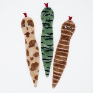 Three Skinny Peltz 3-Pack Large Desert Snakes resembling worms are arranged vertically. One is beige with brown spots, one is green with dark green stripes, and one is brown with lighter brown stripes. All have red crowns and googly eyes.