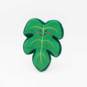 A Squeakie Pattiez - Monstera Leaf shaped like a green leaf with a smiling face and pink cheeks, against a plain white background.