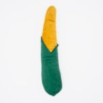 A soft plush toy shaped like an ear of corn with a green husk covering the bottom half and yellow kernels exposed on the top half - Jigglerz® - Corn.