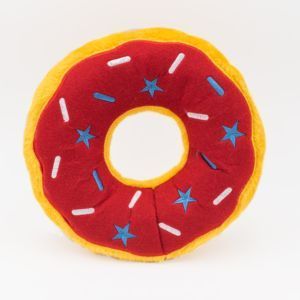 A soft, plush toy shaped like a donut with a red topping adorned with blue stars and white sprinkles - Jumbo Donutz - Americana.