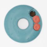 A SmartyPaws Puzzler Donut Slider with two orange covers hiding compartments and a section with visible brown kibble.