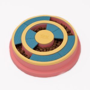 A SmartyPaws Puzzler Feeder Bowl - Wagging Wheel with rotating blue and yellow sections, filled with kibble, designed to provide mental stimulation for pets.