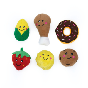 Miniz Multipack - Foods shaped like a corn, drumstick, donut, strawberry, pineapple, and cookie, each with a smiling face and black eyes, arranged in a grid pattern on a white background.