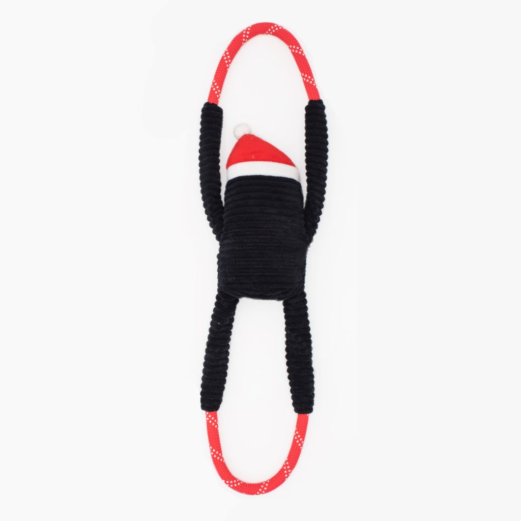 A Holiday RopeTugz® - Penguin with a Santa hat and red loop handles at both ends.
