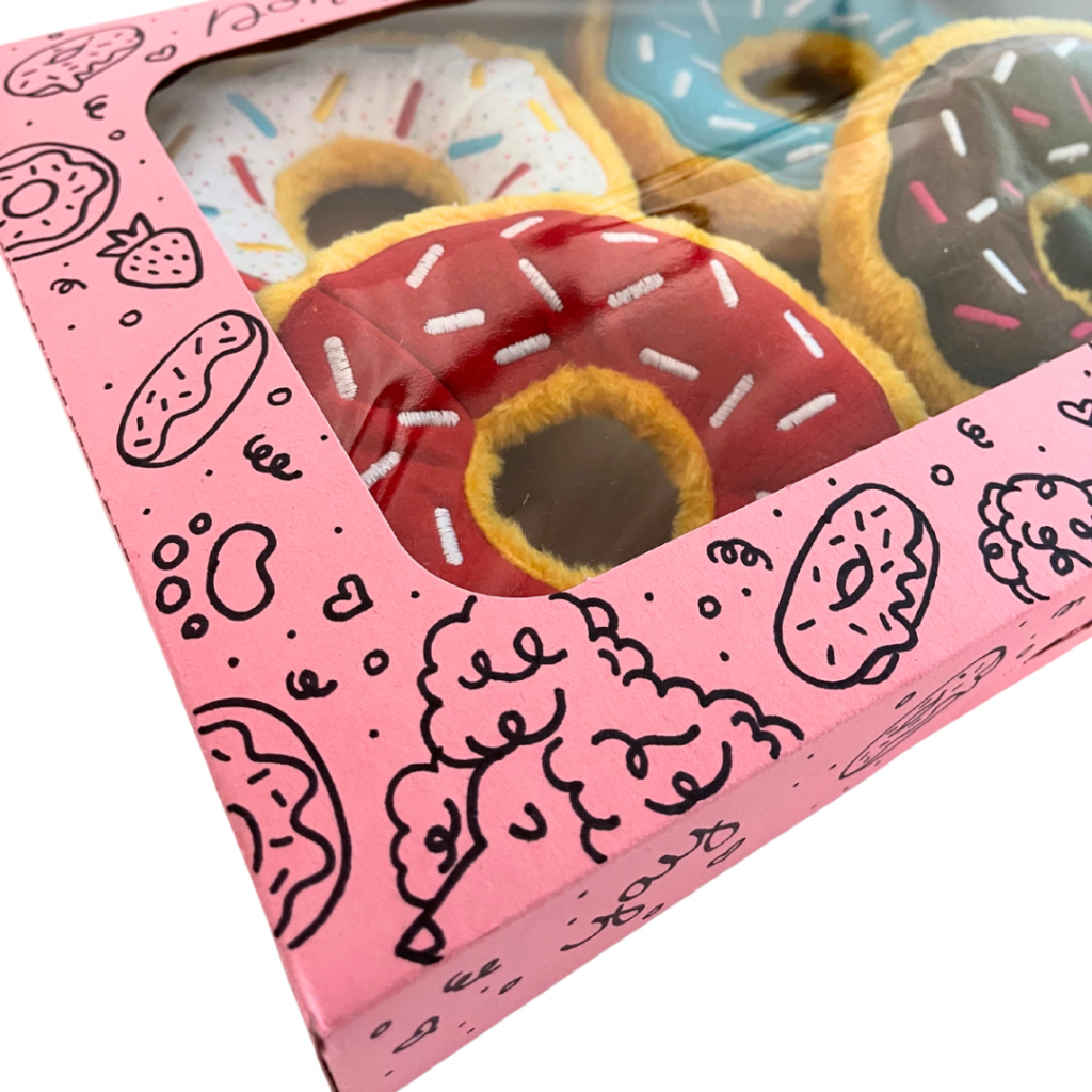 A close up of four donut toys, red, brown, blue and white