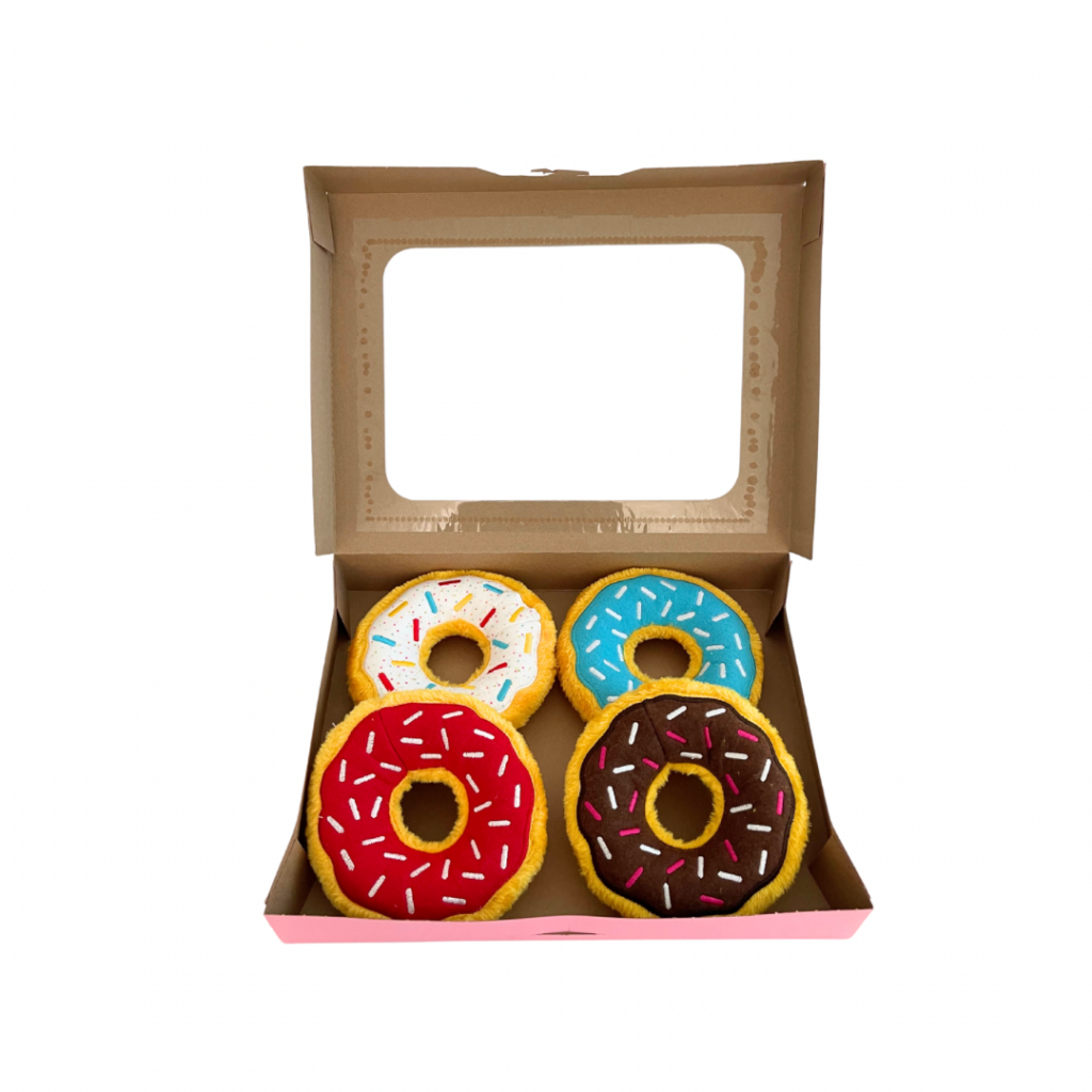 A open case of four donut toys, red, brown, blue and white