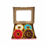 A open case of four donut toys, red, brown, blue and white