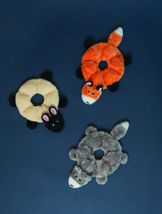 Three stuffed animal toys shaped like rings on a dark blue background. The toys resemble a bunny, a fox, and a raccoon.