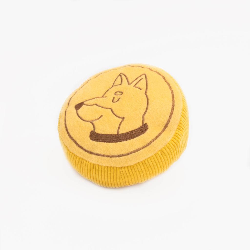 Squeakie Pattiez - Zippy Coin with a cartoon dog's face embroidered on the top, placed on a white background.