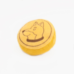 Squeakie Pattiez - Zippy Coin with a cartoon dog's face embroidered on the top, placed on a white background.