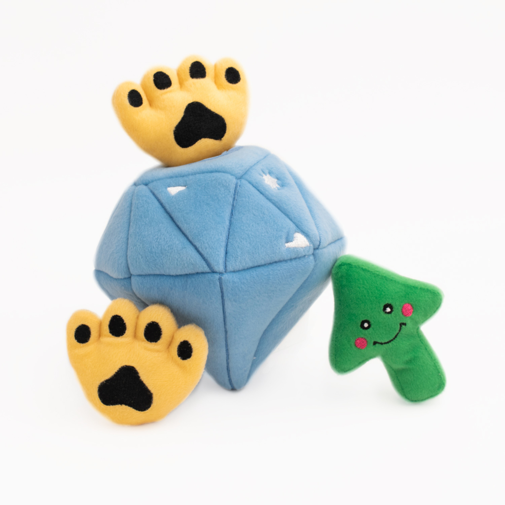 A blue, diamond-shaped plush toy with two yellow paw prints on top and a green tree-shaped plush toy with a smiley face on the right side, **Zippy Burrow® - Diamond Paws**.