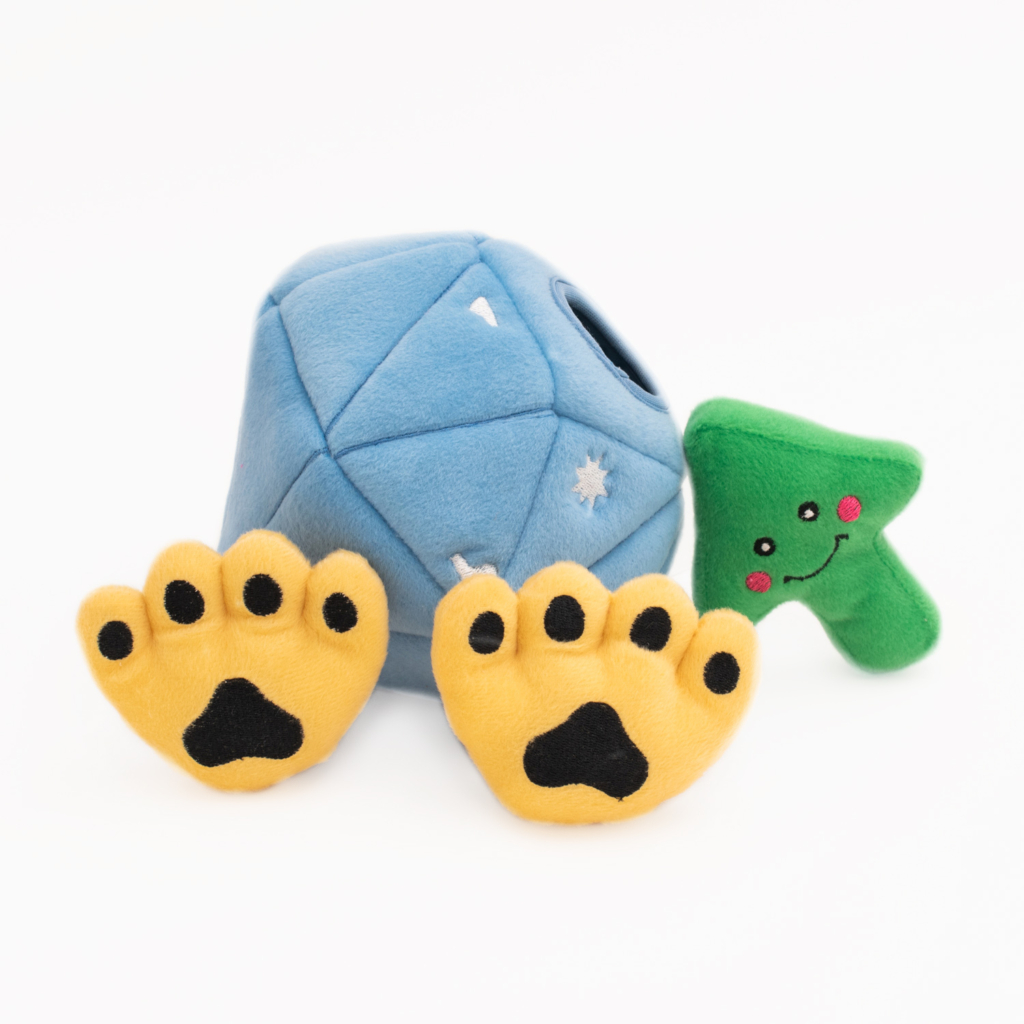 A Zippy Burrow® - Diamond Paws, accompanied by a green tree-shaped toy with a smiling face and two yellow paw-shaped toys with black pads.