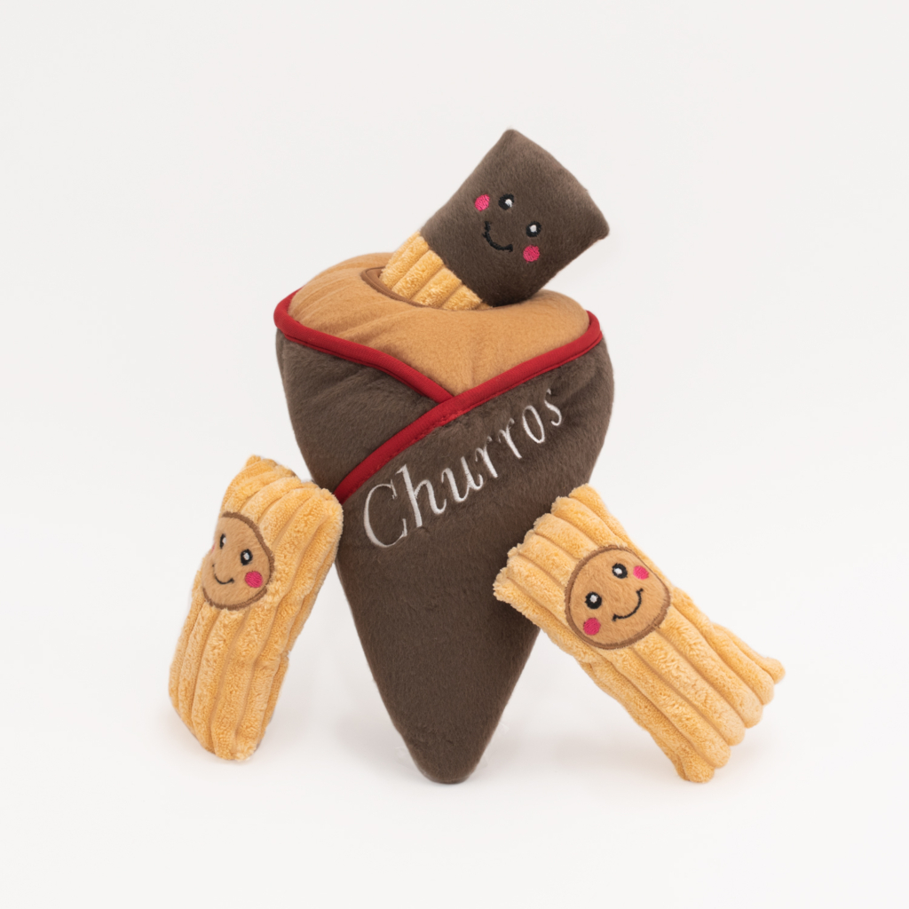 Plush representation of a Zippy Burrow®  - Churro Cone with three smiling churro plushies peeking out. The word 