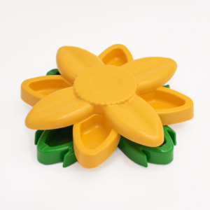 A yellow, flower-shaped silicone mold with green petals, designed for baking or crafting purposes called SmartyPaws Puzzler Sunflower.