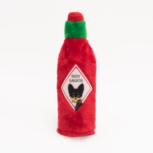 A plush toy shaped like a bottle of hot sauce with a red body, green cap, and a label featuring a cat face and the text "HOT SAUCE" on it: Hot Sauce Crusherz - Pupbasco.