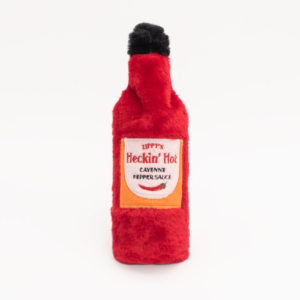 A plush toy shaped like a red hot sauce bottle with the label "Hot Sauce Crusherz - Heckin' Hot." White background.