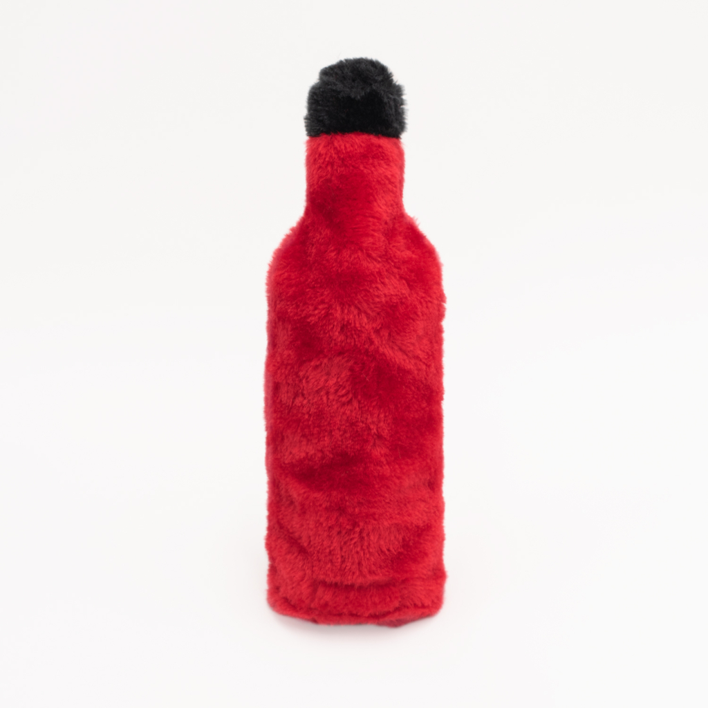 A red, fluffy Hot Sauce Crusherz - Heckin' Hot with a black top stands against a plain white background.