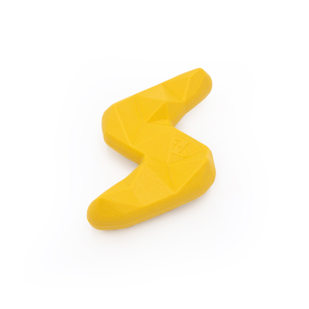 A yellow, ZippyTuff+ Lightning Bolt climbing hold with a textured, geometric surface placed on a white background.