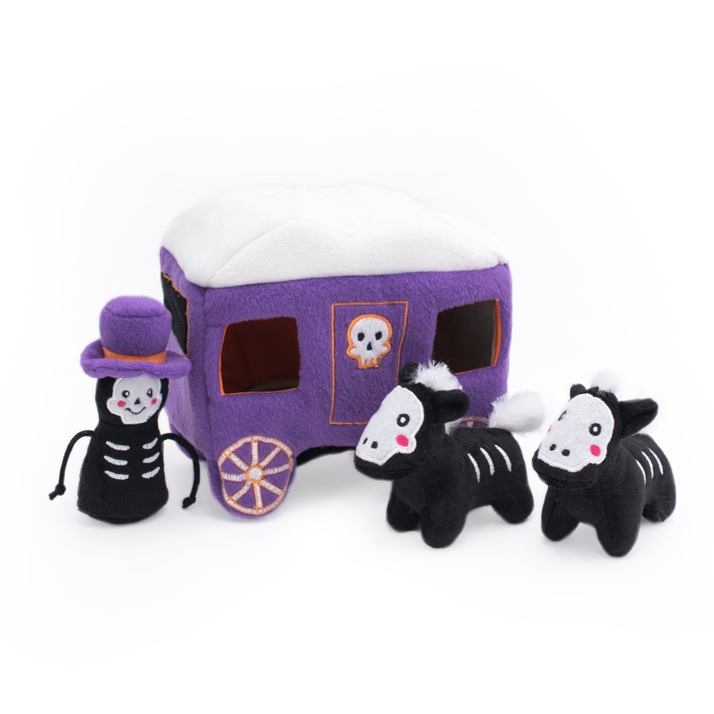Plush toys featuring a smiling skeleton figure with a top hat, a purple and white carriage with skull decorations, and two black and white horse figures are part of the Halloween Burrow® - Haunted Carriage.