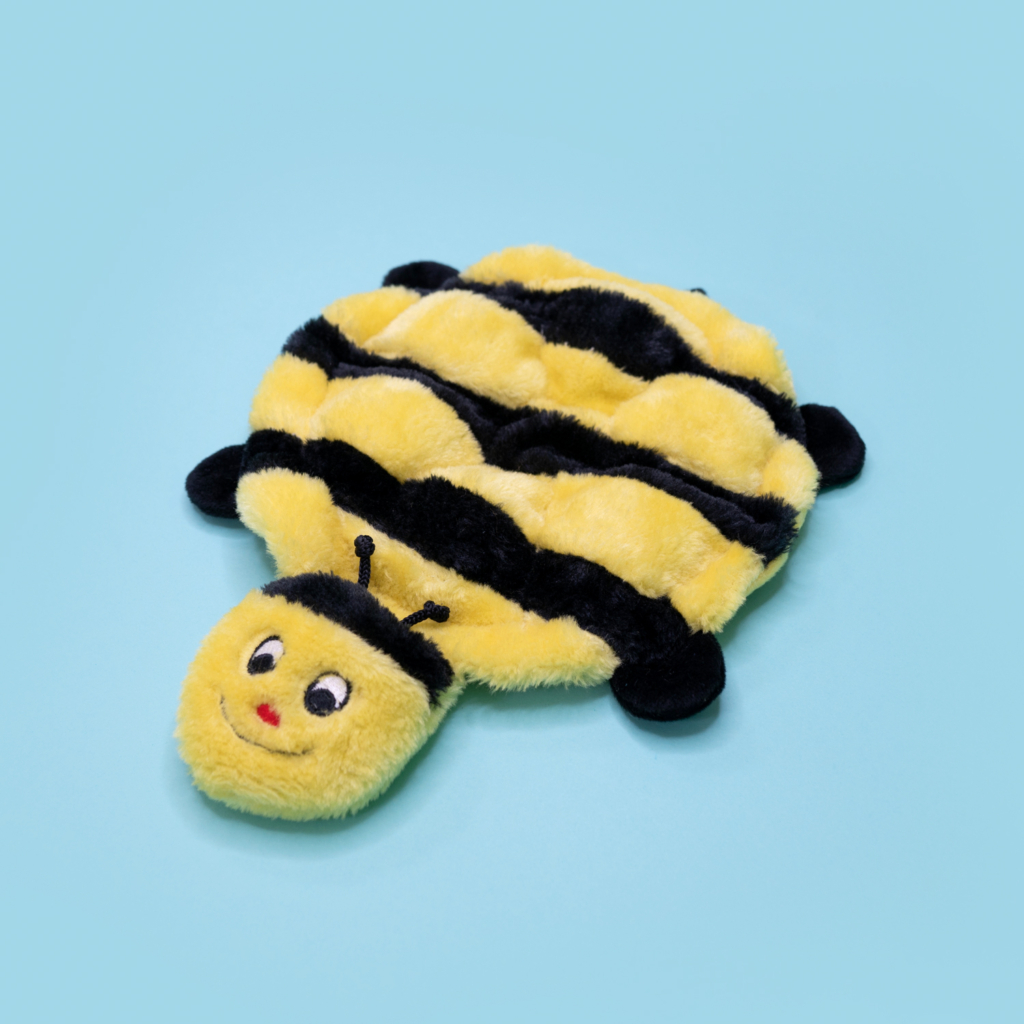 A Squeakie Crawler - Bertie the Bee shaped like a smiling bee with yellow and black stripes is laid flat on a light blue background.