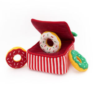 A Holiday Burrow® - Donutz Box with a lid, containing plush donut toys in red, yellow, and green, each decorated with sprinkles.