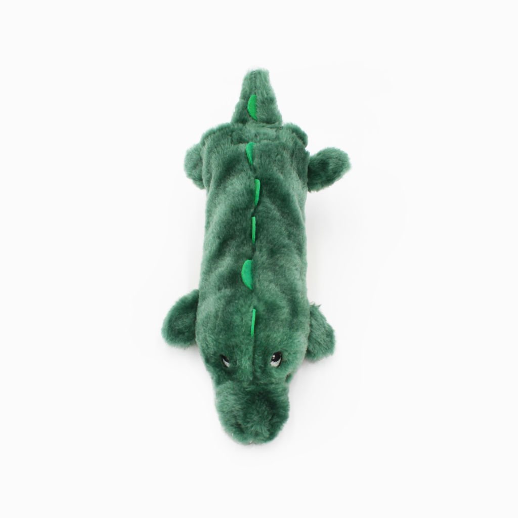 A green plush toy in the shape of an alligator, shown from a top-down perspective on a plain white background.