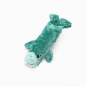 A green, plush toy resembling a sea creature with two white tusks, flippers, and a tail fin.
