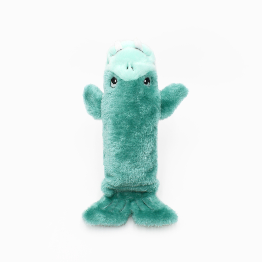 A green plush toy resembling a crocodile with fins instead of legs, standing upright on a plain white background.