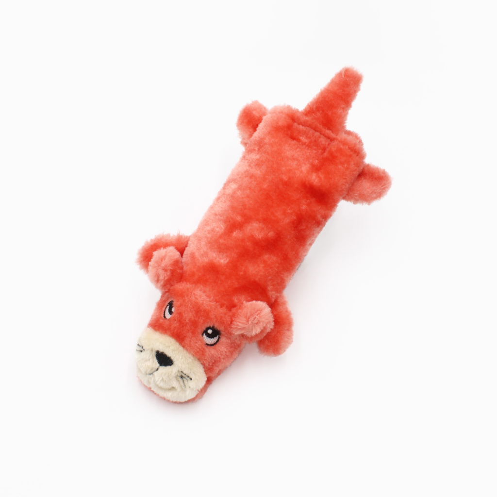 Red plush dog toy with a smiling animal face, four paws, and a tail, lying on a white background.