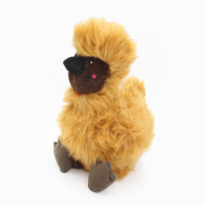 A fluffy, golden-brown stuffed toy resembling a bird with a dark beak and feet, seated upright against a white background.