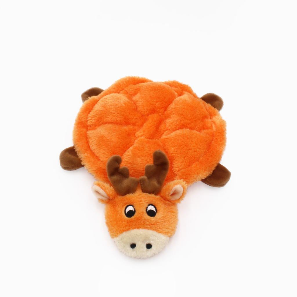 Plush orange moose toy with brown antlers and legs, lying face up on a white background.