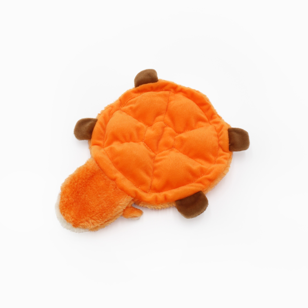 An orange and brown plush turtle toy with a round shell and four small legs.
