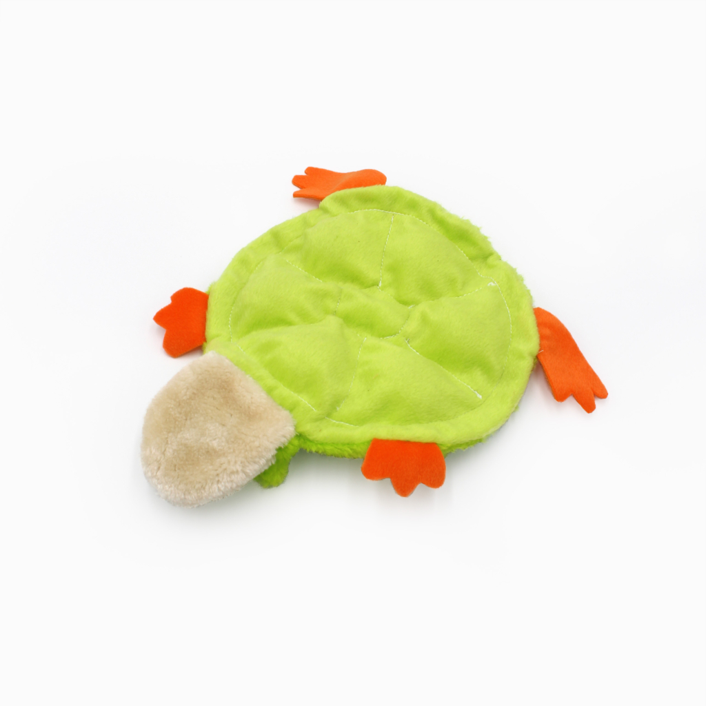 A green and orange stuffed animal toy resembling a turtle with a soft beige head, displayed on a white background.