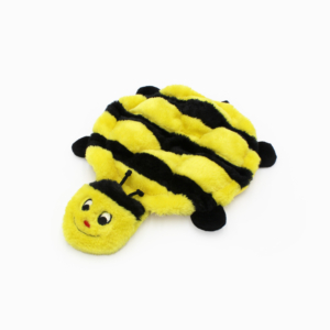 A small, plush toy in the shape of a yellow and black bumblebee with a smiling face, black antennae, and legs.
