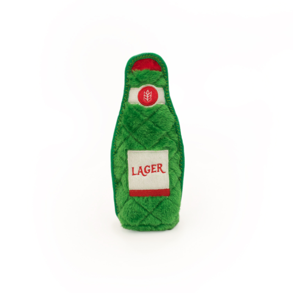 A green plush toy shaped like a beer bottle with a red and white label that reads 