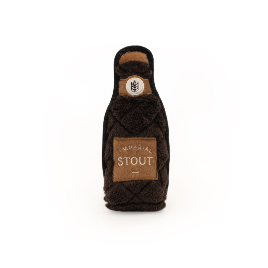 A dark-colored plush toy shaped like a beer bottle with an 