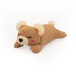 A Snooziez with Shhhqueaker - Bear lying on its stomach with closed eyes, pink cheeks, and beige ears.