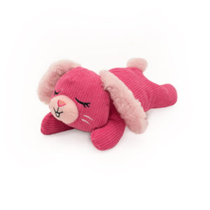 A pink Snooziez with Shhhqueaker - Bunny with closed eyes and a content expression lies on its stomach. The toy features soft, fluffy ears and a small tail.