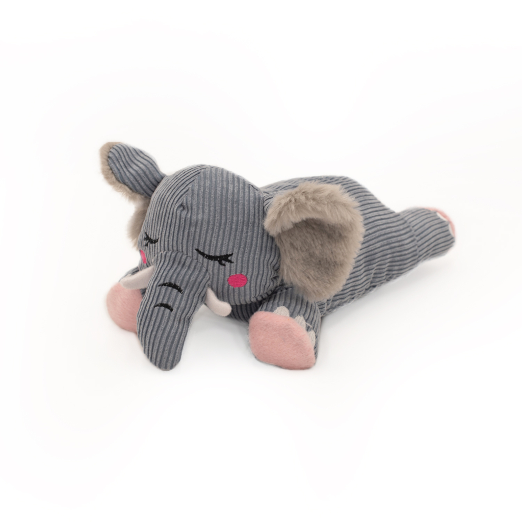 A Snooziez with Shhhqueaker - Elephant with a striped gray body, pink cheeks, closed eyes, and pink toes, lying on its stomach with its trunk extended.