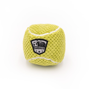 A yellow textured dog toy cube with the label "SportsBallz - Tennis Ball" featuring a soccer ball and stars.