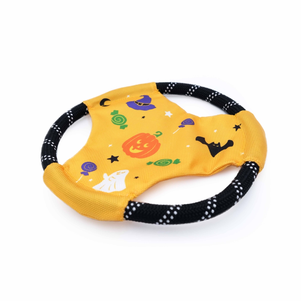 A yellow circular pet toy with black edges, featuring Halloween-themed designs including a pumpkin, ghost, hat, and bats is called the Rope Gliderz - Halloween.