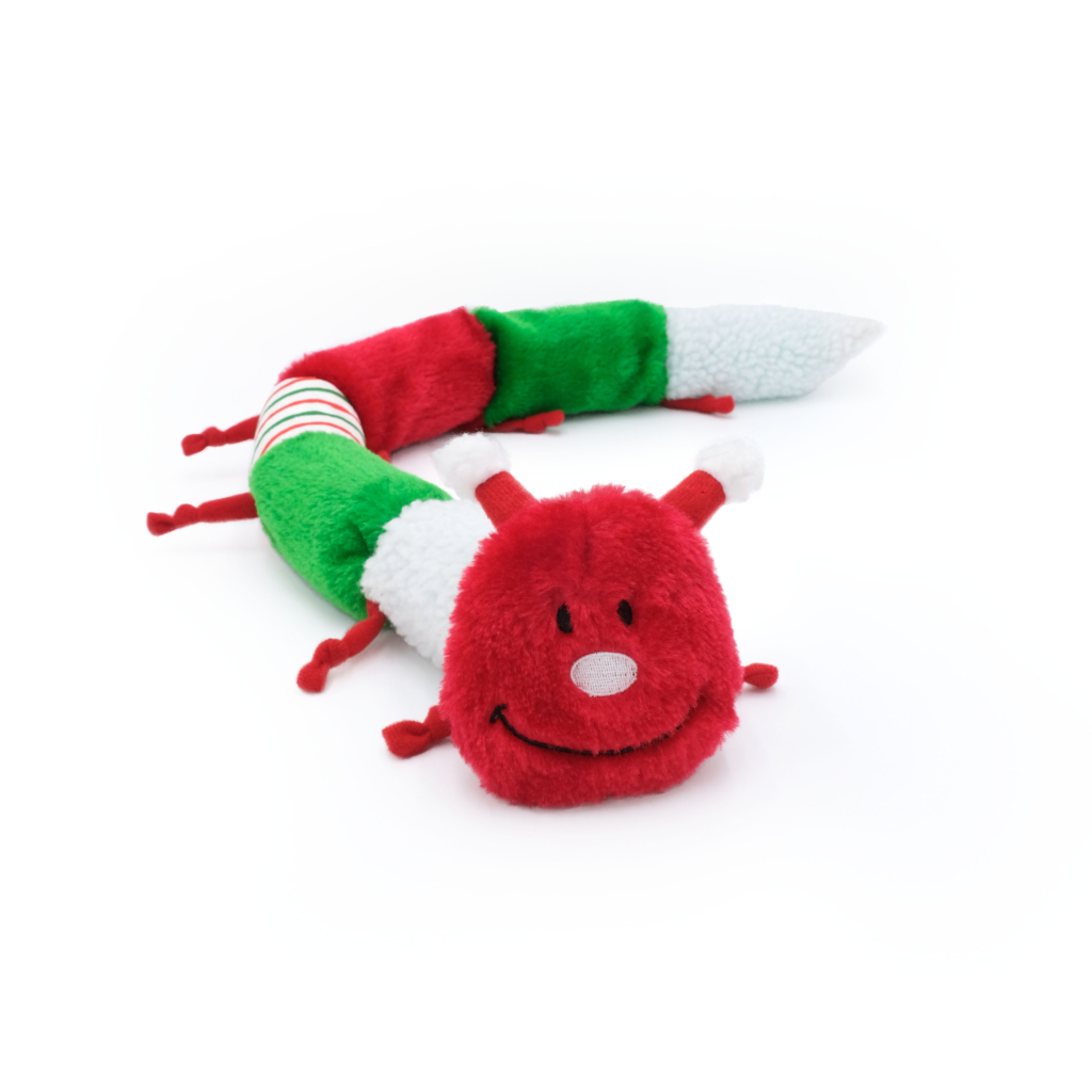 A plush, multicolored Holiday Caterpillar - Deluxe with 7 Squeakers with a red, smiling face, green and red segmented body parts, and small antennae, lying on a white background.