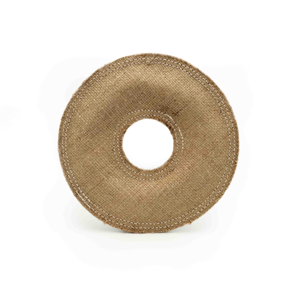 A round, brown fabric ecoZippy Jute Donutz with a hole in the center against a white background.